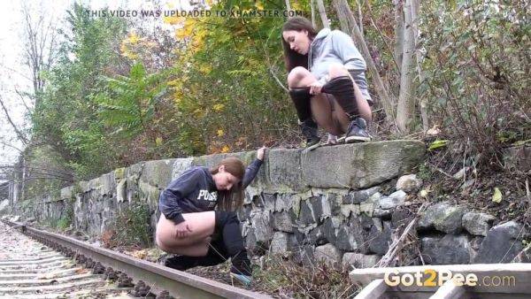 Watch these kinky girls get soaked in pee while getting frisky on the railway - sexu.com on pornsfind.com