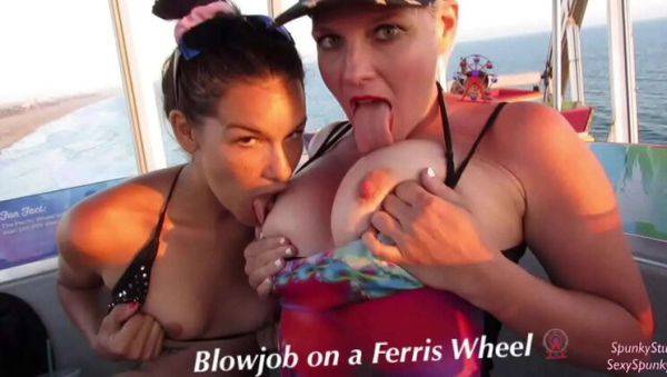 Play the complete video titled : Teen & MILF Give Risky Double Blowjob on Ferris Wheel - Public Threesome Fun!