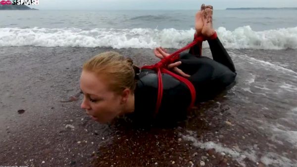 View the HD video named : Lucy Lauren In A Wetsuit - Rope Bondage Escape Challenge On The Beach