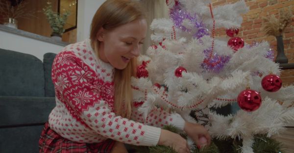 Enjoy watching this full scene : MILF in miniskirt rocks Santa hat while pleasuring herself with a festive dildo on the couch