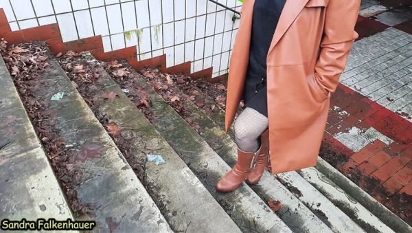 Play the full clip named : Sandra Falkenhauer takes a short outdoor walk in boots and fishnet stockings